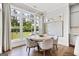 Bright breakfast nook with wood floors, modern lighting fixture, and views of the landscaped backyard at 229 Widener Way, Peachtree City, GA 30269