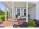 Inviting front porch with brick flooring, white columns, and comfortable seating at 229 Widener Way, Peachtree City, GA 30269