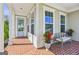 Charming front porch features brick flooring, seating and a light blue door at 229 Widener Way, Peachtree City, GA 30269