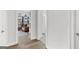 Hallway leading to a room showcasing natural light, neutral walls, and hardwood flooring at 229 Widener Way, Peachtree City, GA 30269