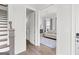 Hallway with stairs leading to a sitting area with a comfortable sofa and natural light at 229 Widener Way, Peachtree City, GA 30269