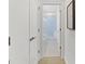 Hallway view leading to a white-tiled bathroom with a glass-enclosed shower at 229 Widener Way, Peachtree City, GA 30269