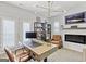 View of the home office with a modern light fixture, brick fireplace, and hardwood flooring at 229 Widener Way, Peachtree City, GA 30269