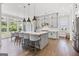 Spacious kitchen with gray cabinets, center island, quartz countertops and stainless steel appliances at 229 Widener Way, Peachtree City, GA 30269