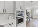 Kitchen with stainless steel oven, white countertops, cabinets, and view to breakfast nook at 229 Widener Way, Peachtree City, GA 30269