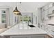 Bright kitchen island with white countertop and black faucet, and a view to the backyard at 229 Widener Way, Peachtree City, GA 30269