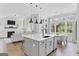 Open kitchen with island seating overlooks the living room, fireplace and backyard play set at 229 Widener Way, Peachtree City, GA 30269