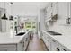 Kitchen with gray cabinets, center island with breakfast bar and hardwood flooring at 229 Widener Way, Peachtree City, GA 30269