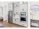 Modern kitchen featuring stainless steel appliances, gray cabinets, and a view of the breakfast nook at 229 Widener Way, Peachtree City, GA 30269