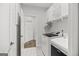 Convenient laundry room with modern washer and dryer, overhead cabinets, and stylish patterned flooring at 229 Widener Way, Peachtree City, GA 30269