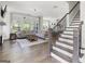 Open-concept living room with hardwood floors, a large sectional sofa, and a staircase at 229 Widener Way, Peachtree City, GA 30269
