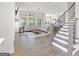 Spacious living room featuring hardwood floors, a comfortable sectional sofa, and large windows with backyard views at 229 Widener Way, Peachtree City, GA 30269