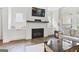 Bright living room featuring a white brick fireplace with wood mantel and built in cabinets at 229 Widener Way, Peachtree City, GA 30269