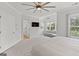 Spacious main bedroom with sitting area, en suite bath, and view of ceiling fan at 229 Widener Way, Peachtree City, GA 30269