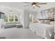 Bright main bedroom with large windows, sitting area, plush carpet, and a ceiling fan at 229 Widener Way, Peachtree City, GA 30269