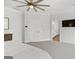 Open bedroom with ceiling fan, door to en suite bathroom, and view of walk-in closet at 229 Widener Way, Peachtree City, GA 30269