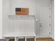 Organized mudroom featuring a bench, coat hooks, and storage shelves for convenience at 229 Widener Way, Peachtree City, GA 30269