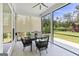Cozy screened porch featuring a dining table set, ceiling fan, and views of the private backyard at 229 Widener Way, Peachtree City, GA 30269