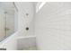 Walk-in shower featuring white subway tile, a built-in bench, and rain shower head at 229 Widener Way, Peachtree City, GA 30269