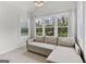 Sitting area with large windows showing wooded exterior views and pull out sofa at 229 Widener Way, Peachtree City, GA 30269