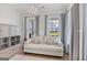 Bright sitting room featuring a comfortable sofa, built-in shelving, and large windows with neighborhood views at 229 Widener Way, Peachtree City, GA 30269