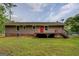 Exterior view of the home with a spacious deck, perfect for outdoor entertaining and relaxation at 170 Hidden Pines Drive, Covington, GA 30016