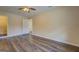 A secondary bedroom with wood-look flooring, neutral walls, and ceiling fan at 170 Hidden Pines Drive, Covington, GA 30016