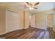 Bedroom with wood-look flooring, double closet, ceiling fan, and access to bathroom at 170 Hidden Pines Drive, Covington, GA 30016