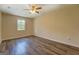 Another bedroom with wood-look flooring, ceiling fan, and a window at 170 Hidden Pines Drive, Covington, GA 30016
