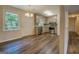 An eat-in kitchen with wood floors, stainless appliances, and beige cabinets at 170 Hidden Pines Drive, Covington, GA 30016