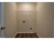 Laundry area with wood-look flooring and connections for washer and dryer at 170 Hidden Pines Drive, Covington, GA 30016