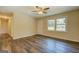 Bright living room with updated flooring, a ceiling fan, and abundant natural light through windows at 170 Hidden Pines Drive, Covington, GA 30016