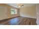 Inviting living room showcasing modern flooring, a ceiling fan, and a front-facing window at 170 Hidden Pines Drive, Covington, GA 30016
