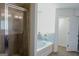 Modern bathroom showcasing glass-enclosed shower and soaking tub with tile accents at 524 Harmony Way, Locust Grove, GA 30248