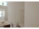Bathroom featuring a large mirror, wood vanity, toilet, and tub-shower combo at 524 Harmony Way, Locust Grove, GA 30248