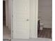 Bright bathroom with white five-panel door, soaking tub, and wood-look flooring at 524 Harmony Way, Locust Grove, GA 30248