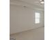 Bright bedroom featuring neutral carpet, white walls and a single window at 524 Harmony Way, Locust Grove, GA 30248