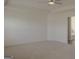 Large bedroom featuring neutral carpet, a fan and a door leading to the bathroom at 524 Harmony Way, Locust Grove, GA 30248