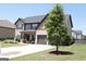 Beautiful exterior view of a two-story home with a lush green lawn and spacious driveway leading to the garage at 524 Harmony Way, Locust Grove, GA 30248