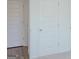 Bright hallway with white paneled doors and contrasting gray wood-look floors at 524 Harmony Way, Locust Grove, GA 30248