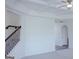 Hallway with coffered ceiling, staircase with iron spindles, and arched doorway at 524 Harmony Way, Locust Grove, GA 30248