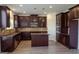 Well-appointed kitchen featuring dark cabinetry, stainless steel appliances, and a center island at 524 Harmony Way, Locust Grove, GA 30248
