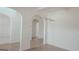 Bright living area showcasing white walls, archways, modern light fixture, and vinyl plank flooring, creating a seamless flow at 524 Harmony Way, Locust Grove, GA 30248