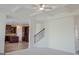 Spacious living room with a coffered ceiling, open to the kitchen and staircase at 524 Harmony Way, Locust Grove, GA 30248