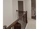 Elegant staircase featuring dark wood railing with decorative wrought iron spindles at 524 Harmony Way, Locust Grove, GA 30248