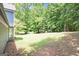 Large backyard with lush green grass and mature trees, offering privacy at 1478 Interlaken Pass, Jonesboro, GA 30238