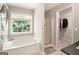 Bathroom features a soaking tub, stand up shower, and a view of the backyard at 1478 Interlaken Pass, Jonesboro, GA 30238