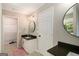This bathroom features double sinks, tile floors, a mirror, and a closet at 1478 Interlaken Pass, Jonesboro, GA 30238