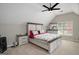 Spacious bedroom with sloped ceilings, a rustic bed frame, and a large window at 1478 Interlaken Pass, Jonesboro, GA 30238
