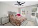 Bedroom with a plush, leopard-print bed, two windows, and a modern ceiling fan at 1478 Interlaken Pass, Jonesboro, GA 30238
